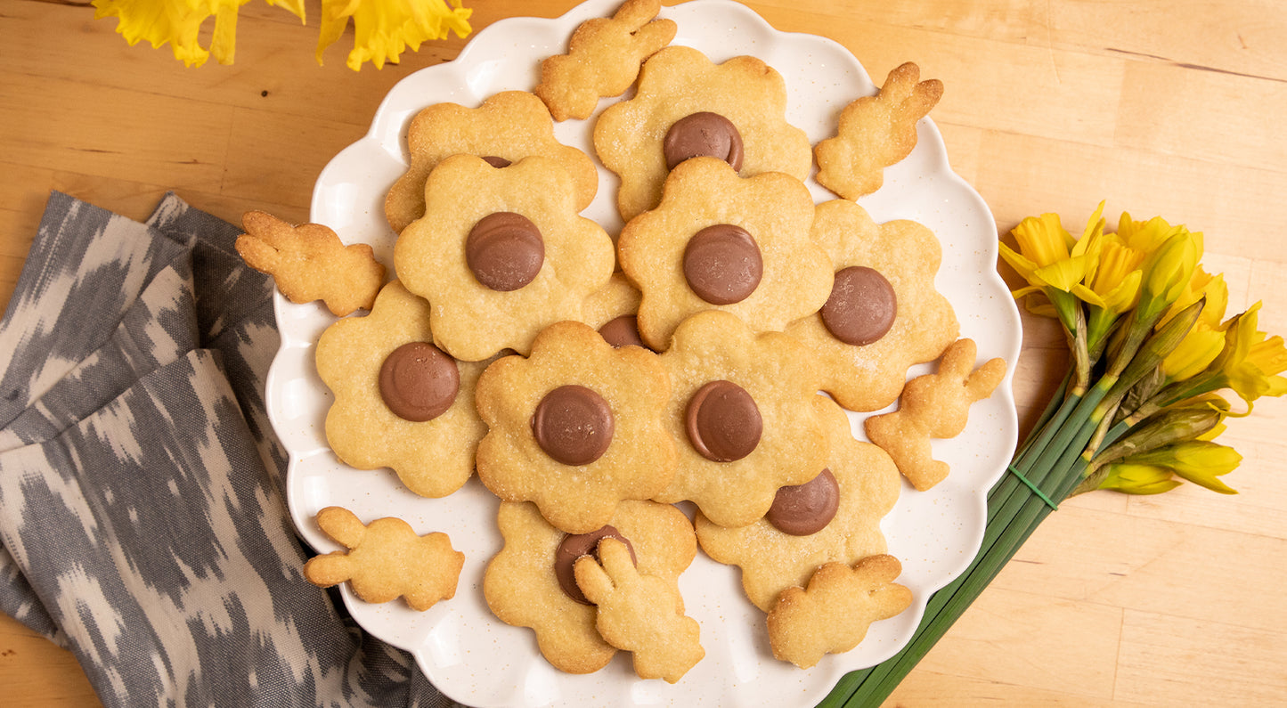 Image depicts a plate with flower shaped shortbread